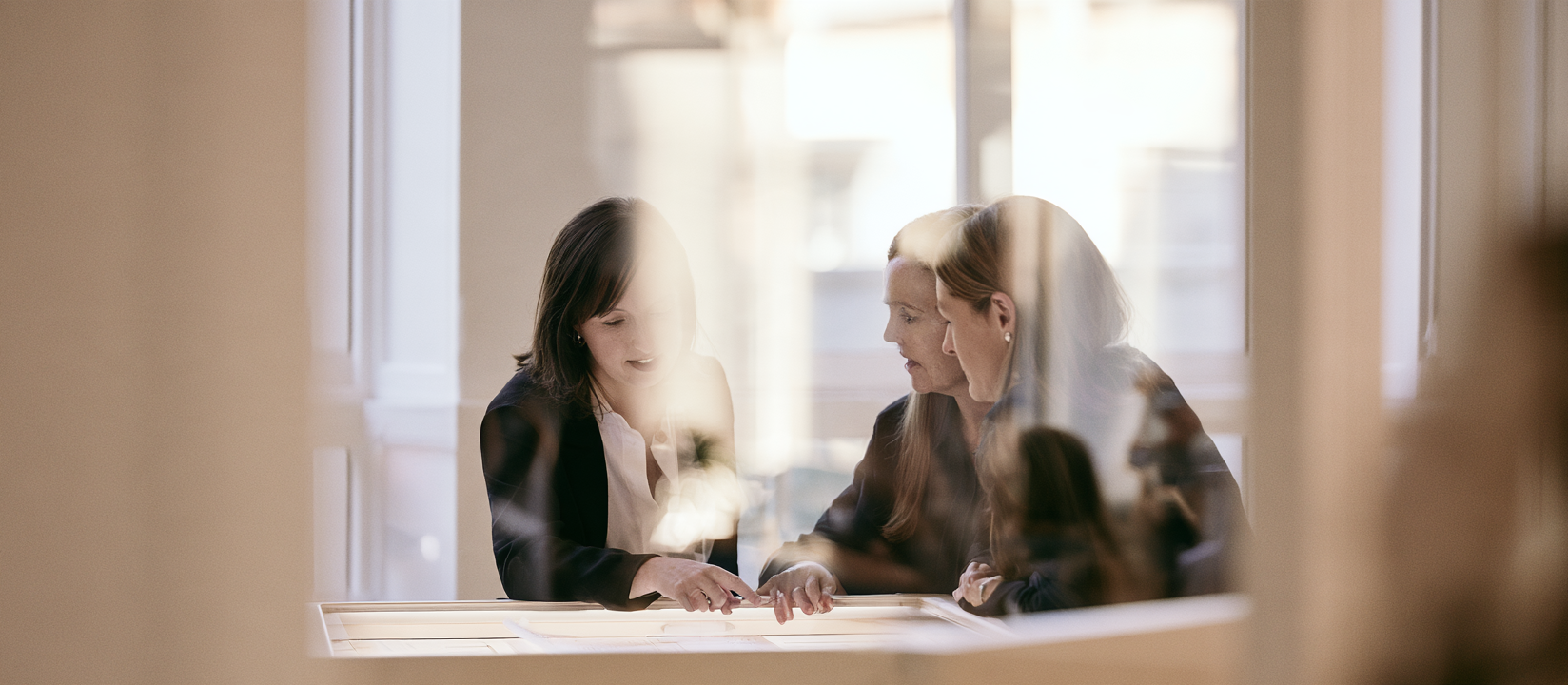 A team reviewing files together across a table